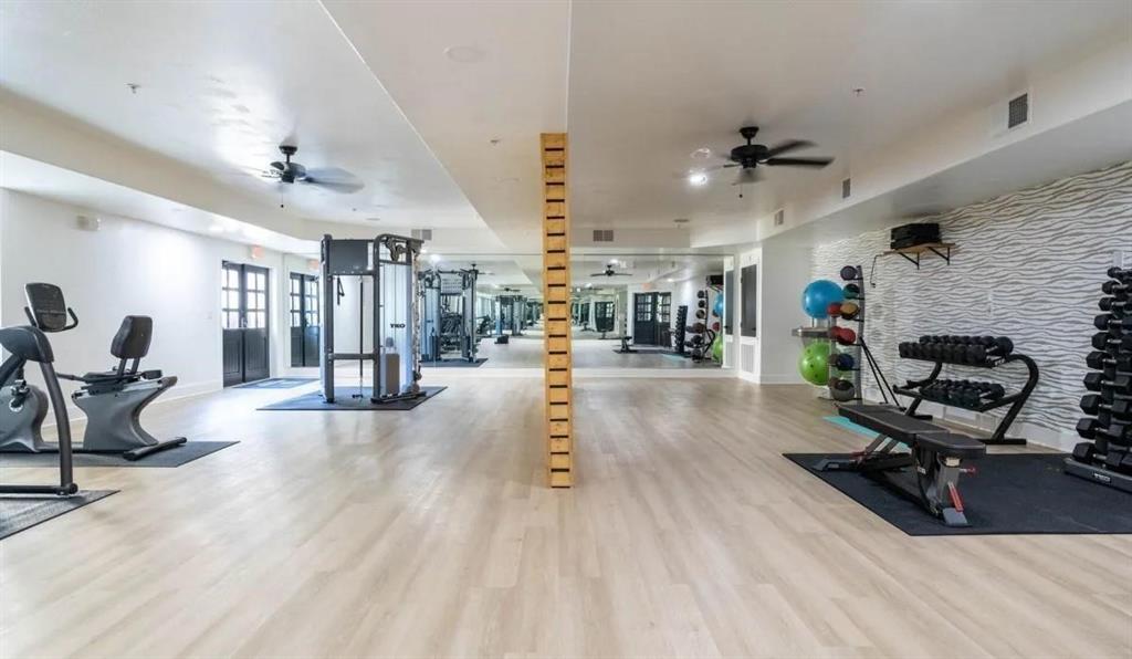 a living room filled with furniture and a wooden floor