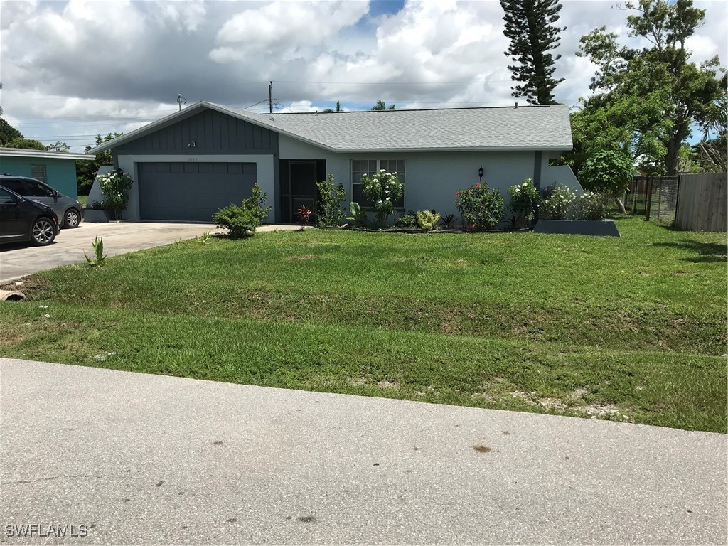 a front view of house with garden