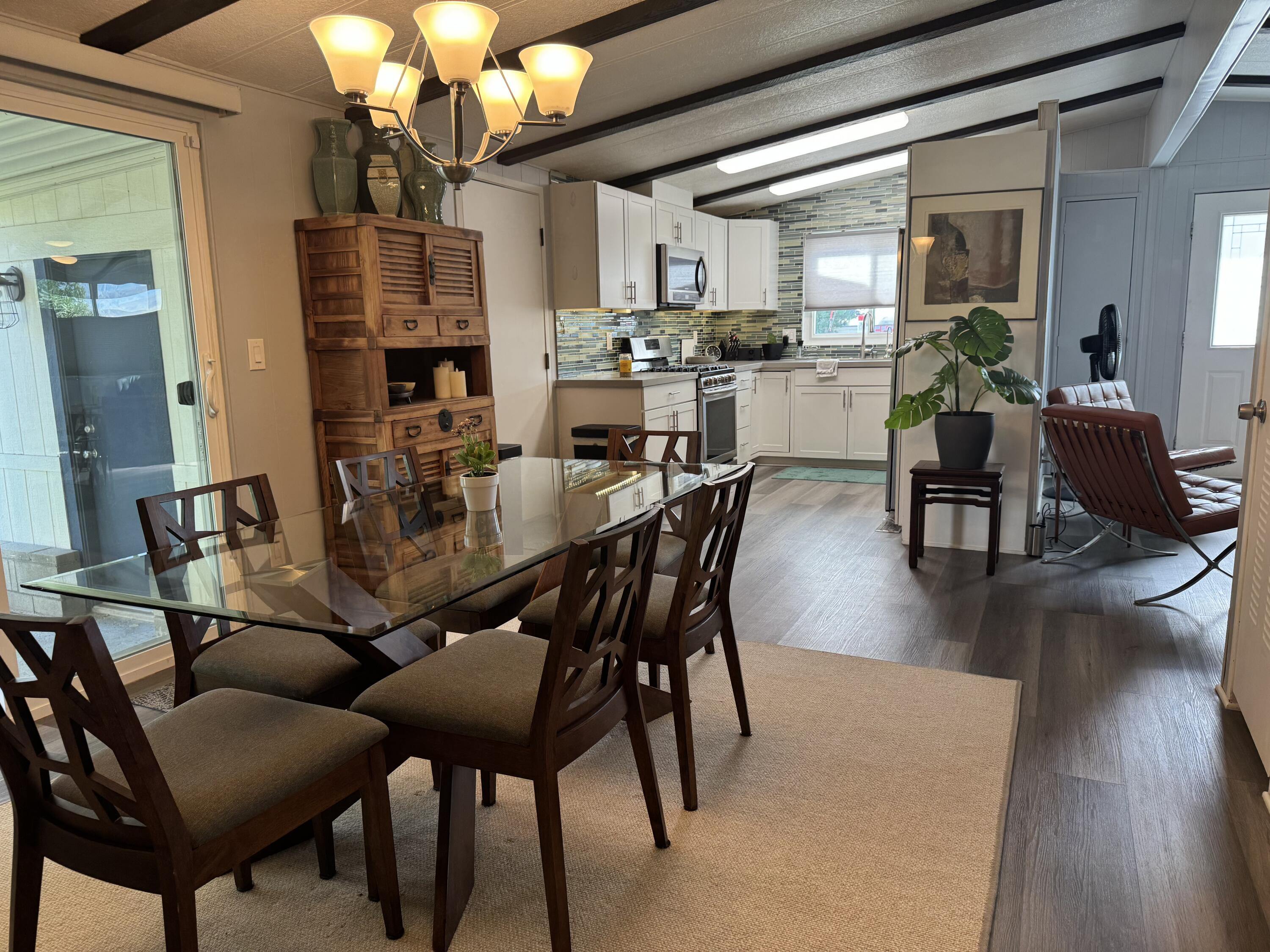 a view of a dining room with furniture and wooden floor