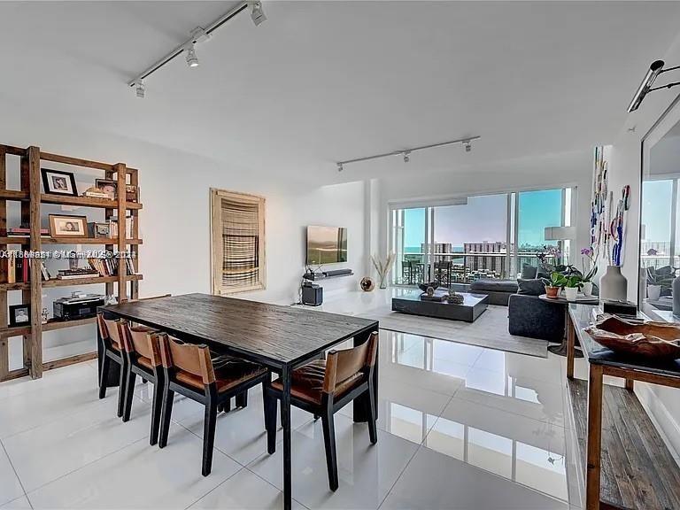 a view of a dining room with furniture and a book shelf