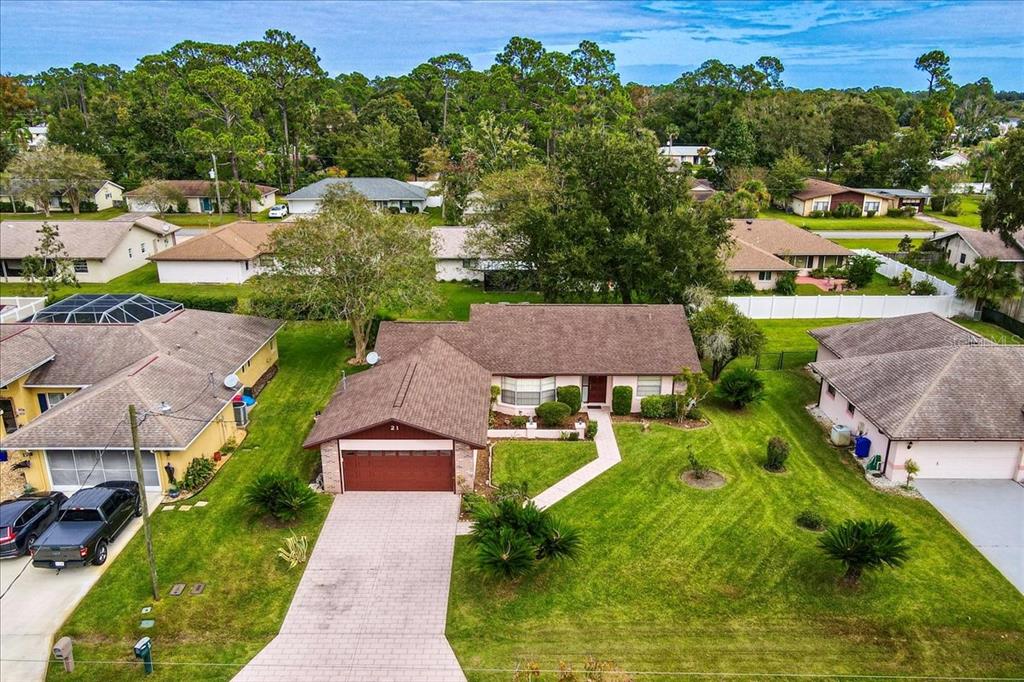 an aerial view of multiple houses with yard