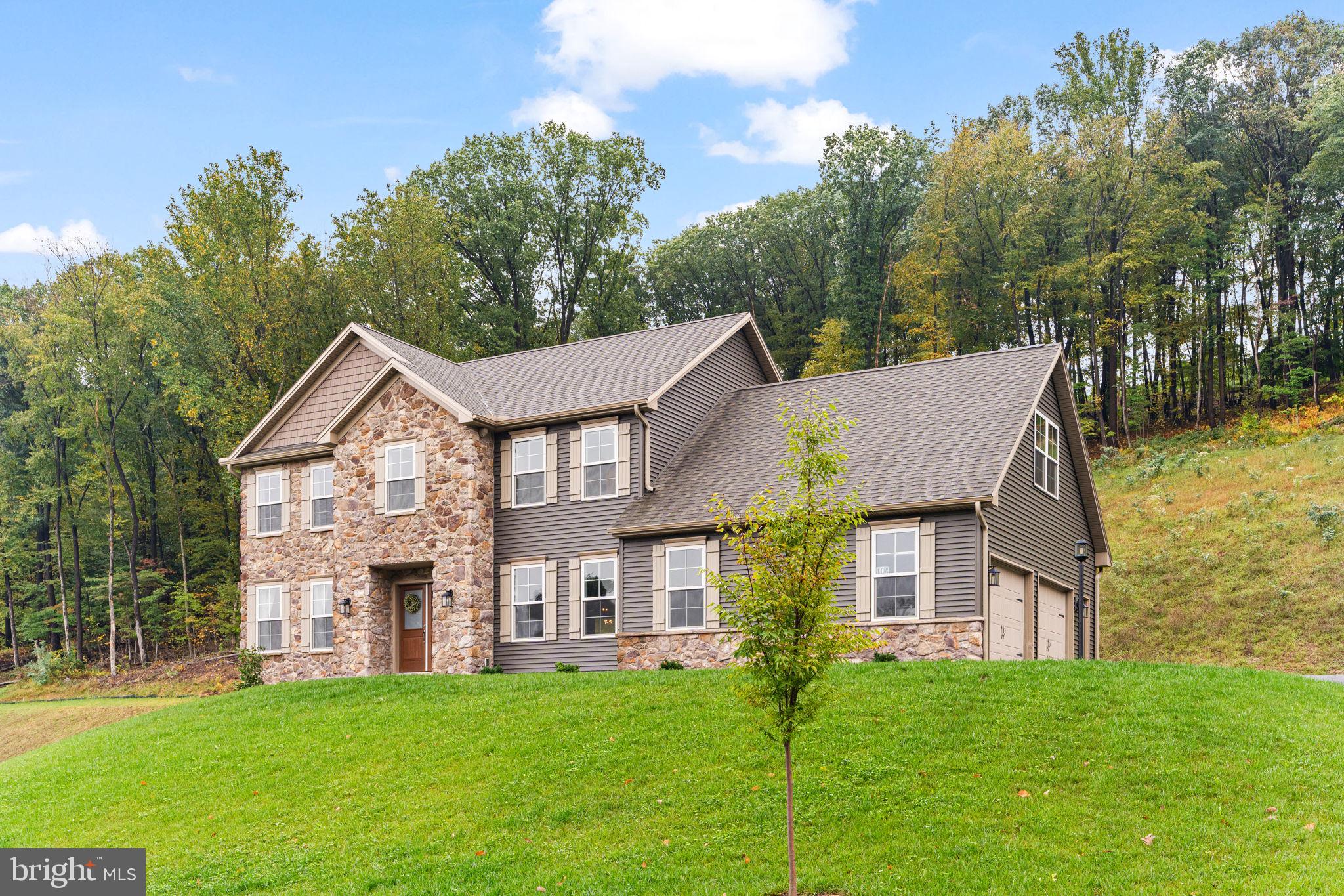 a aerial view of a house next to a big yard and large trees