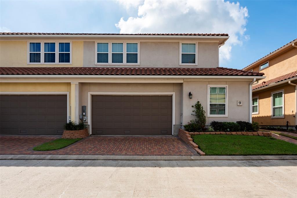 a front view of a house with a yard and garage