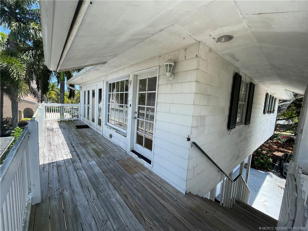 a view of balcony with wooden floor and fence