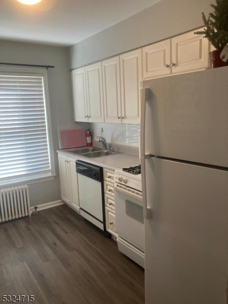 a kitchen with stainless steel appliances a stove a refrigerator and cabinets