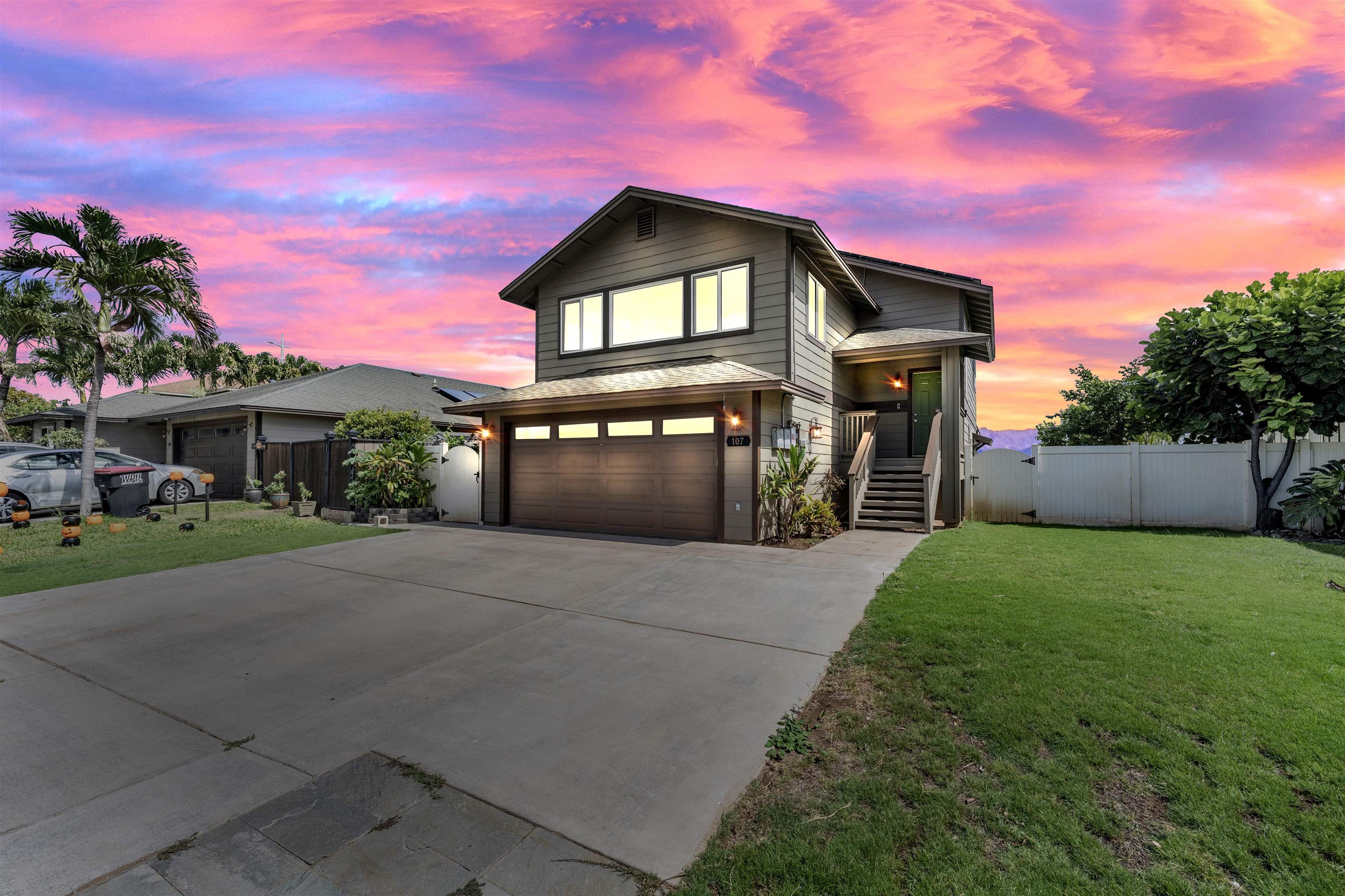 a front view of a house with a yard and garage