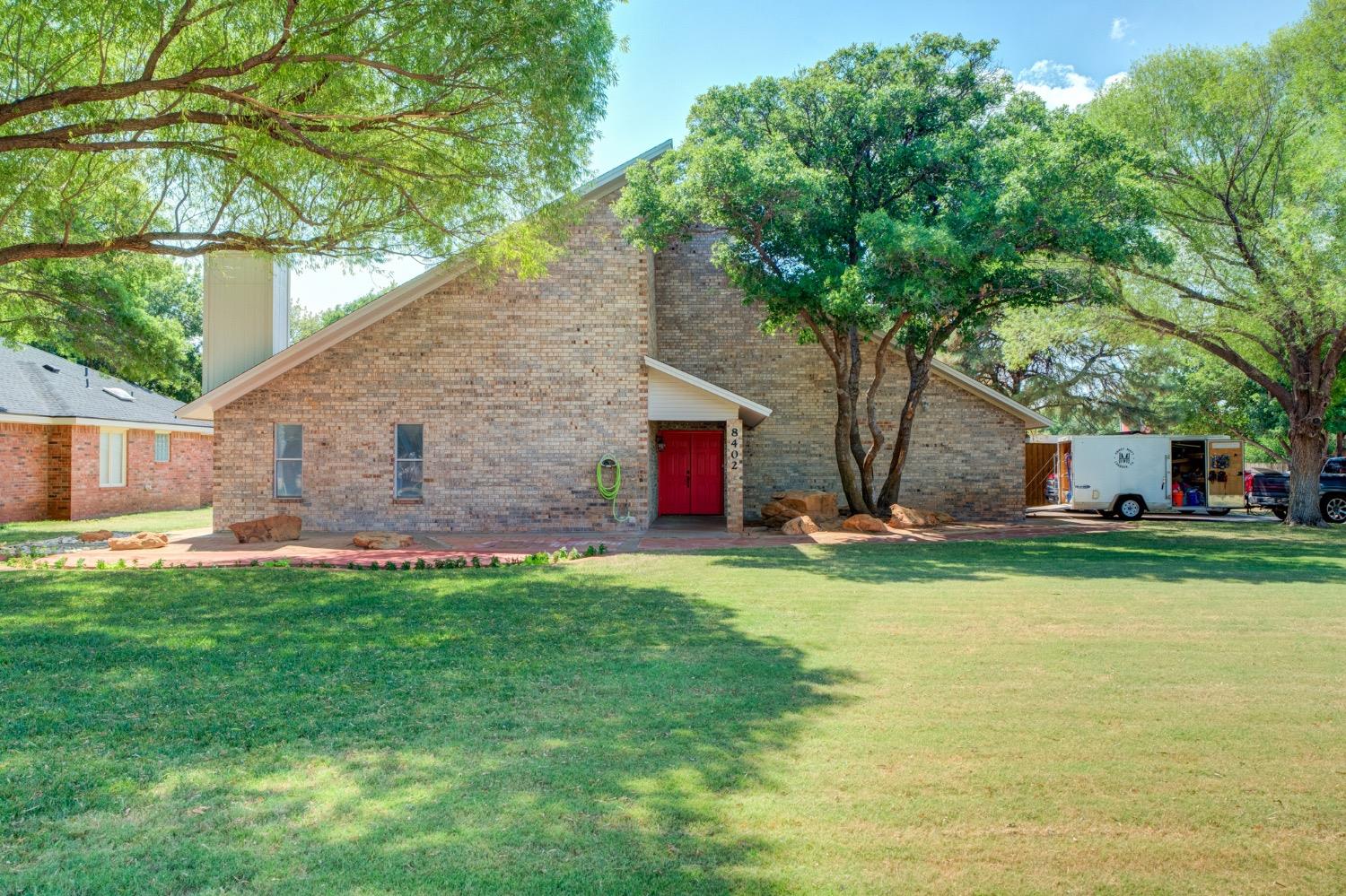 a front view of house with yard and green space