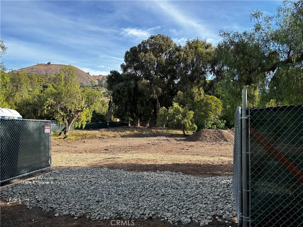 a view of a yard with wooden fence