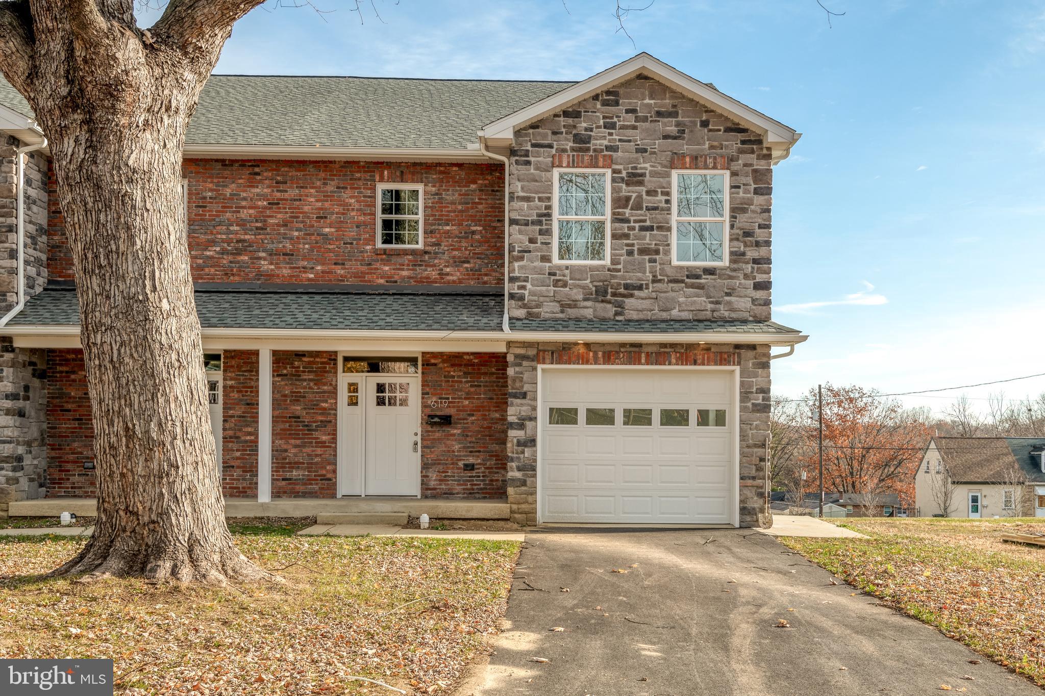 a view of a house with a yard and garage