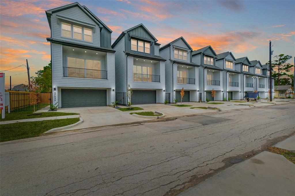 a front view of a residential apartment building with a yard