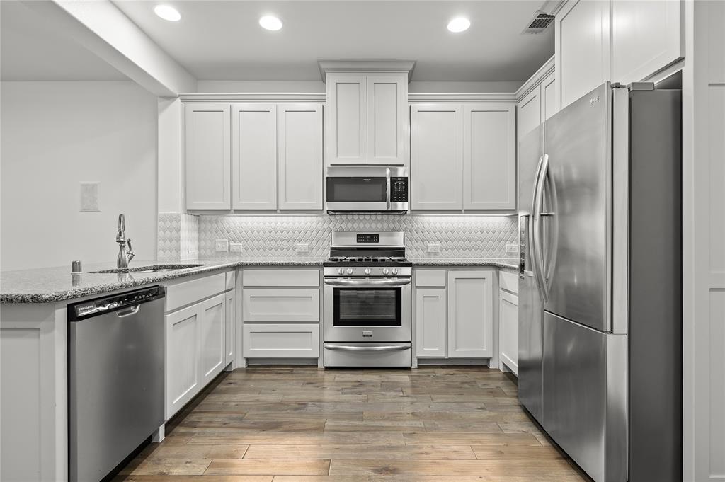 a kitchen with a refrigerator stove and microwave