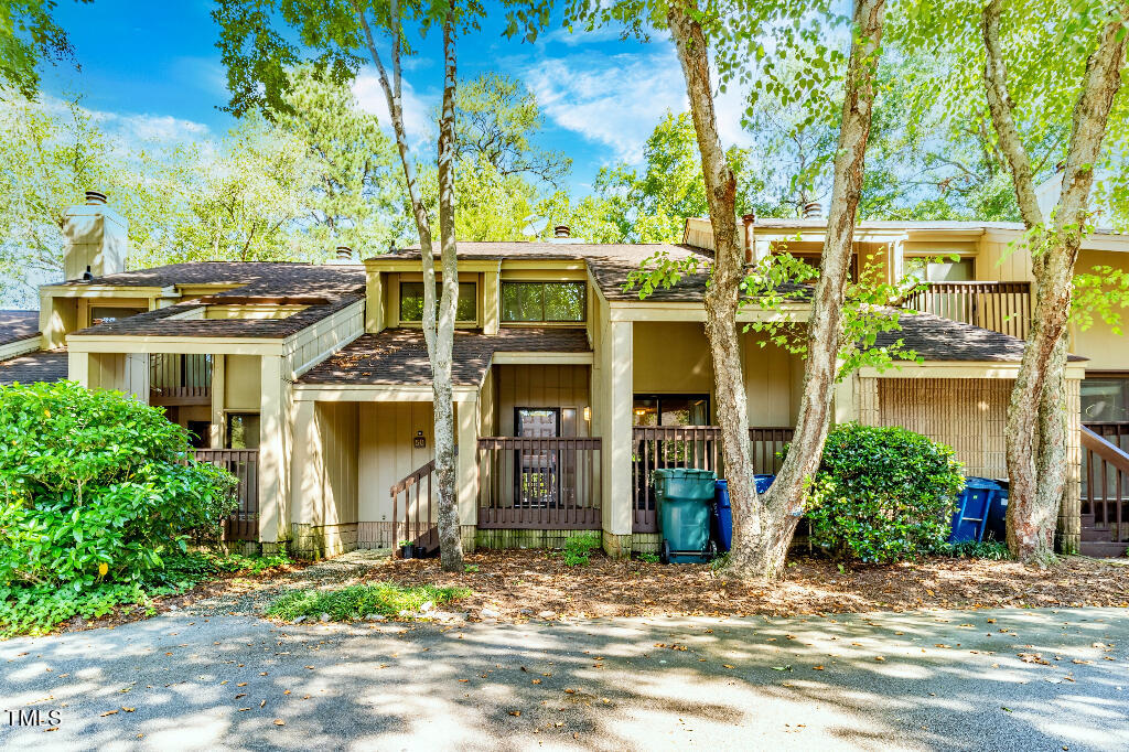 front view of a house with a tree