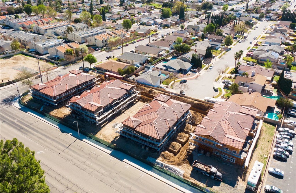 an aerial view of a residential houses with yard