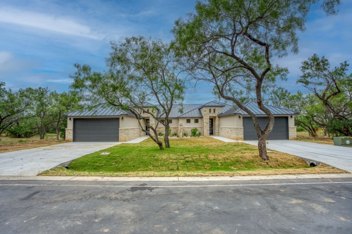 a house that has a tree in front of it