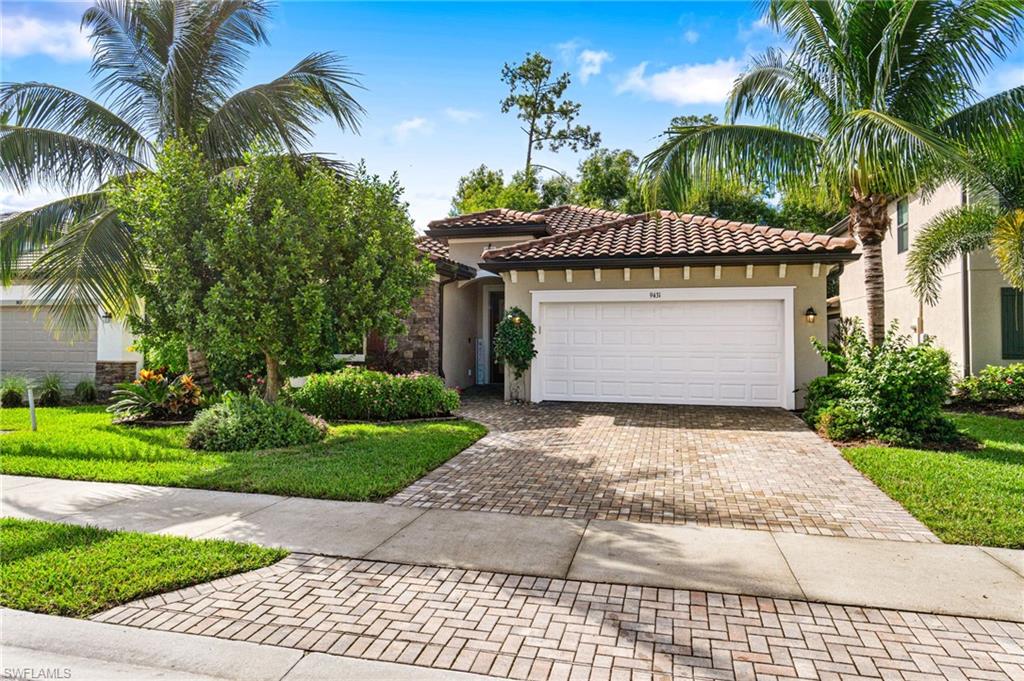 a front view of a house with a yard and palm trees