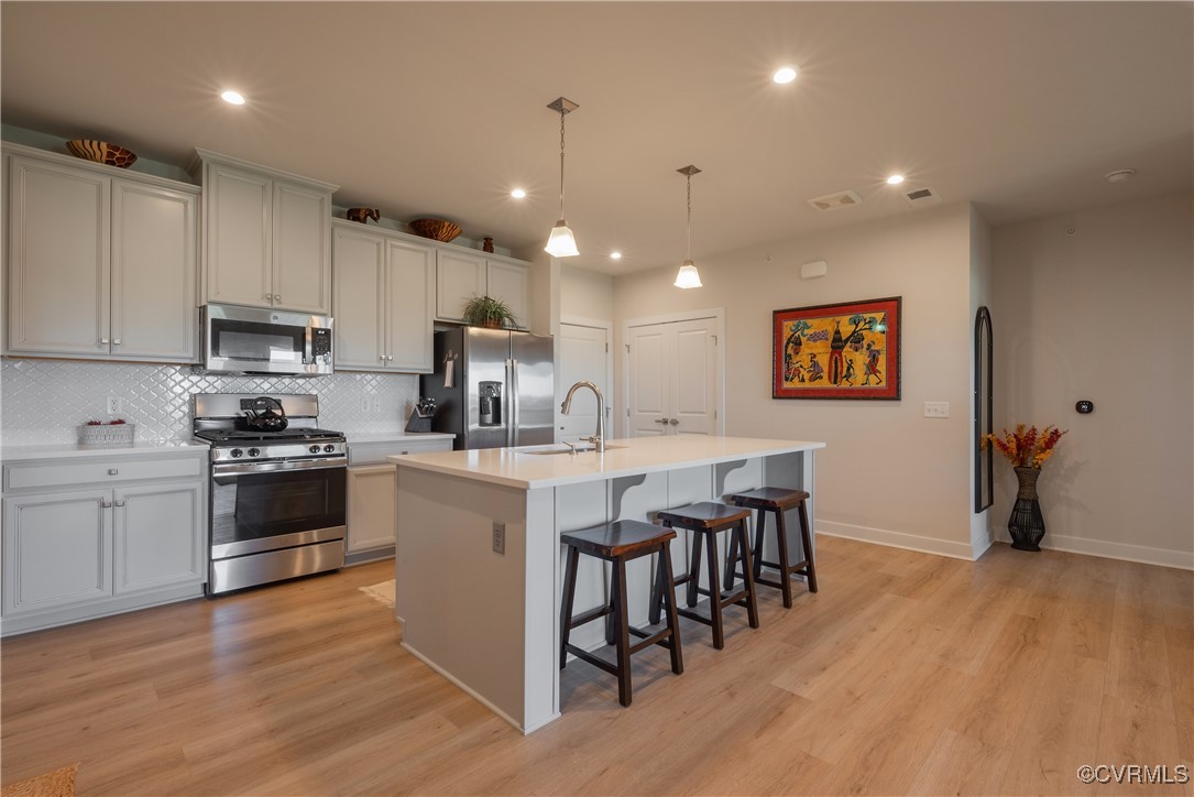 a kitchen with a sink cabinets and wooden floor