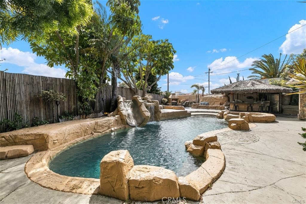 a swimming pool with outdoor seating and outdoor seating