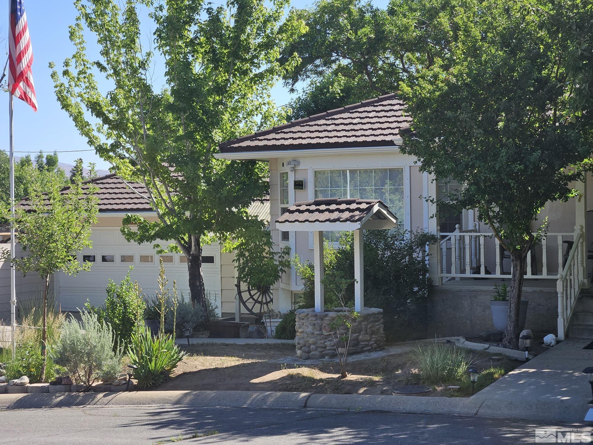 a front view of a house with garden