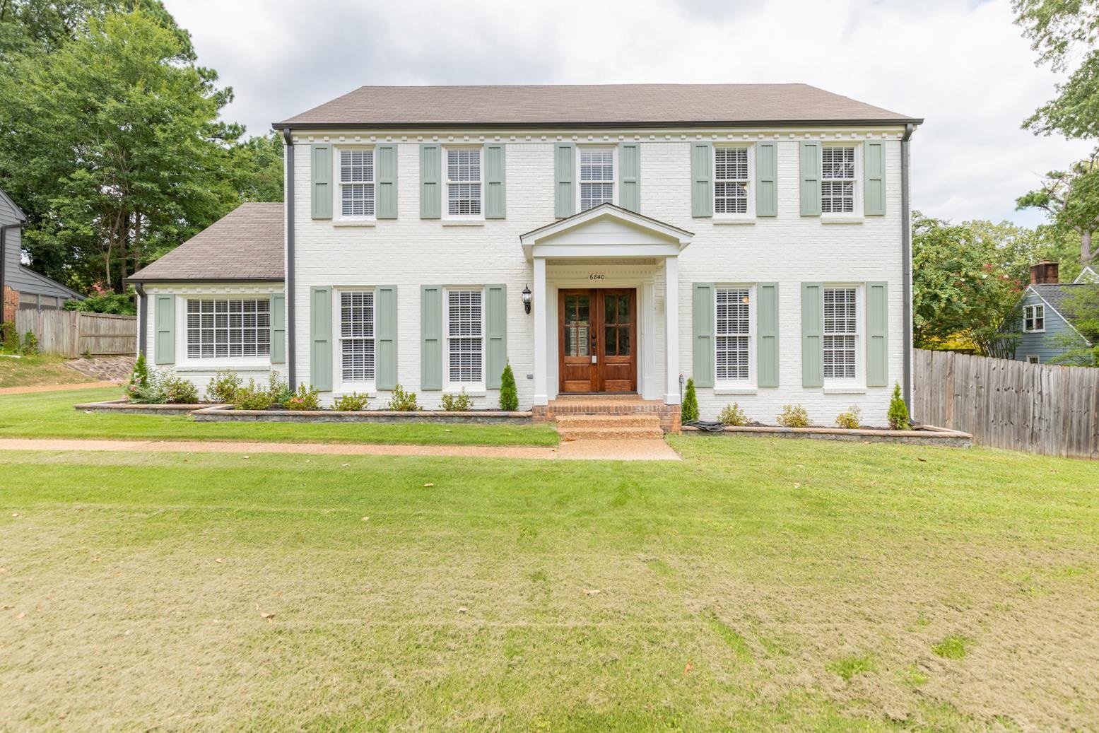 Colonial inspired home with a front lawn