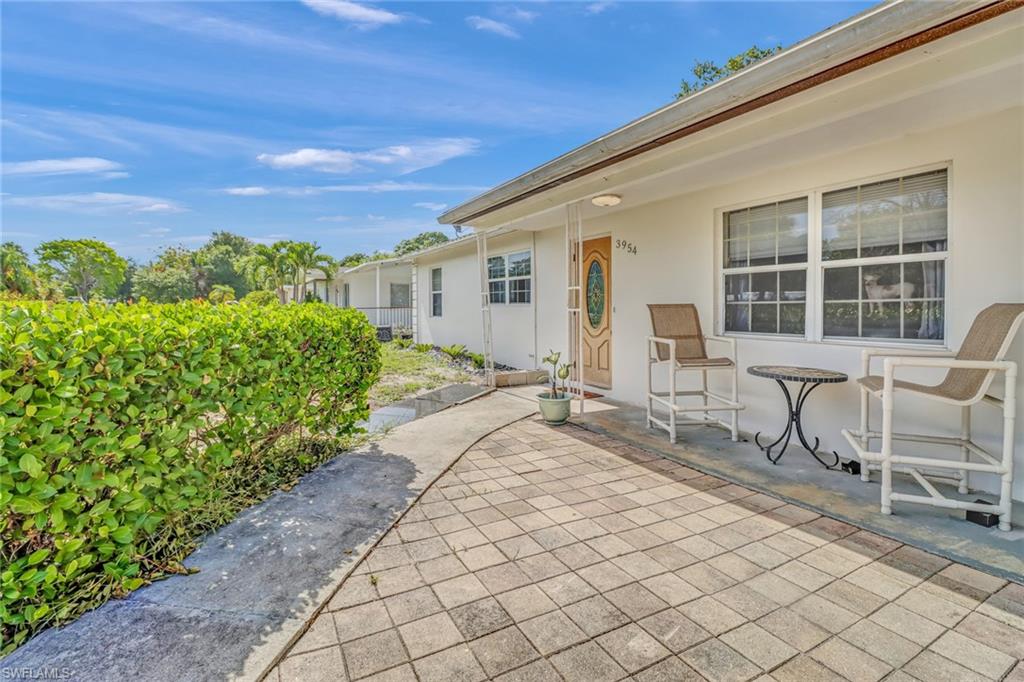 a house with yard and outdoor seating