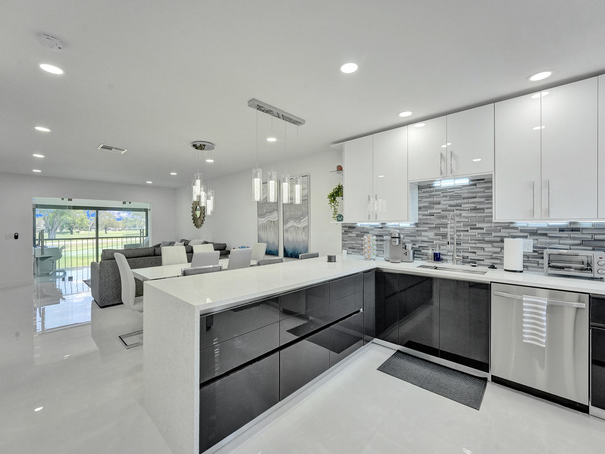 a kitchen with counter top space sink stainless steel appliances and window