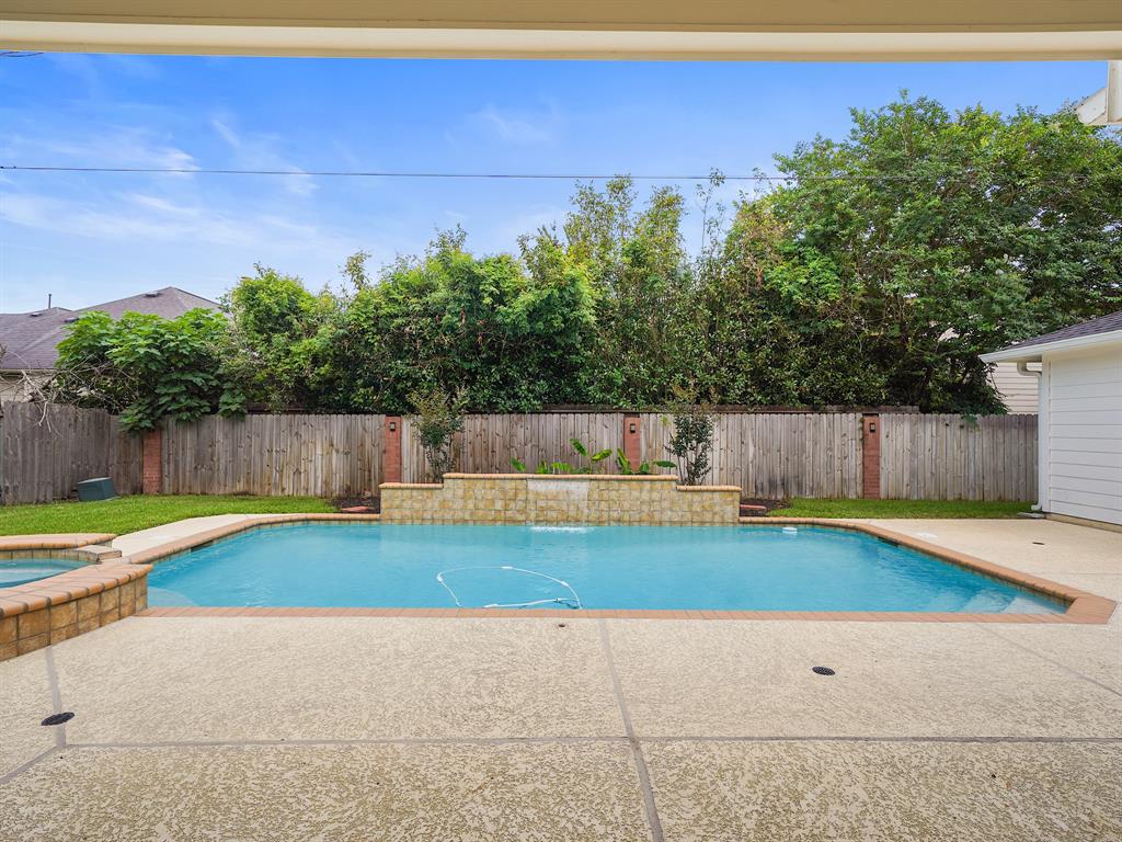 Imagine being able to enjoy this heated pool with waterfall and hot tub all year around!