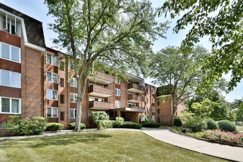 a front view of a residential apartment building with a yard