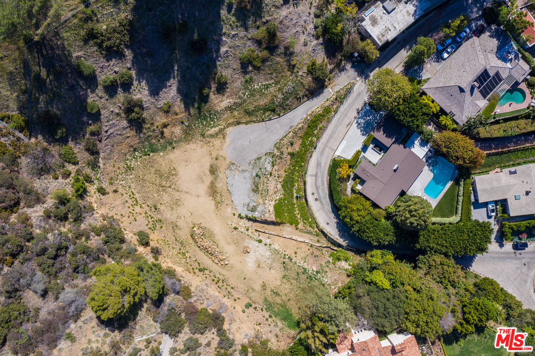 an aerial view of a house with a garden and swimming pool