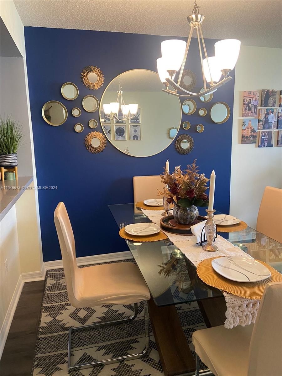 a view of a dining room with furniture and chandelier