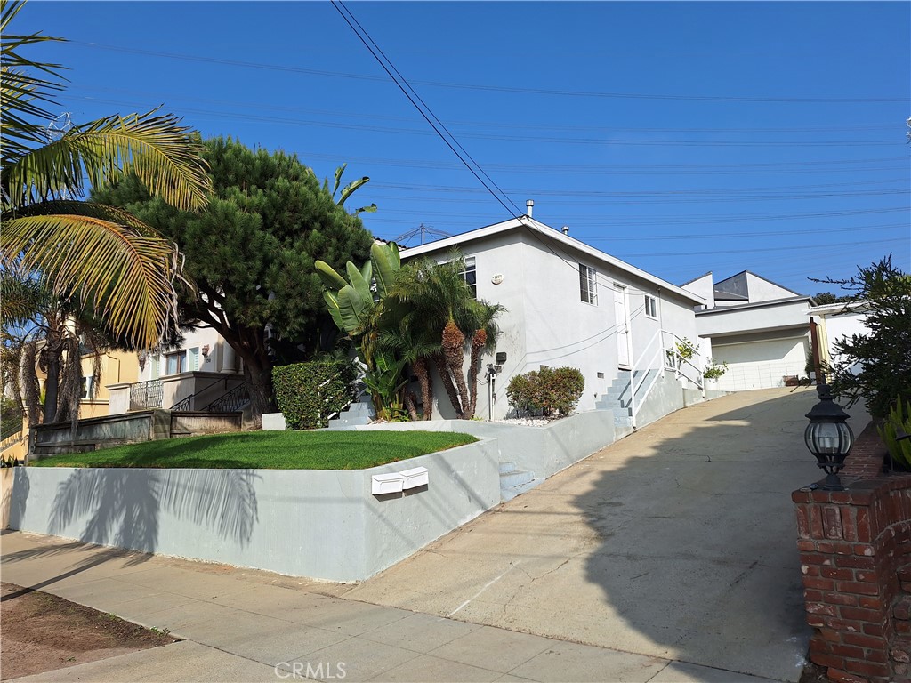 a view of a street with a house in the background