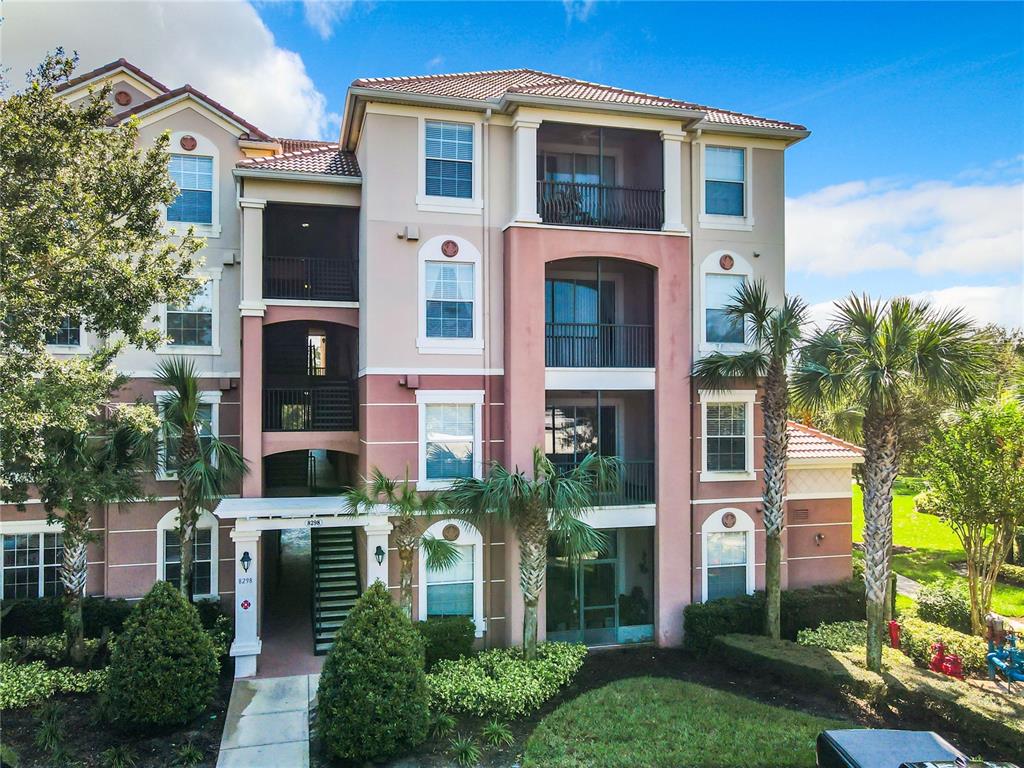 a front view of a multi story residential apartment building with a yard