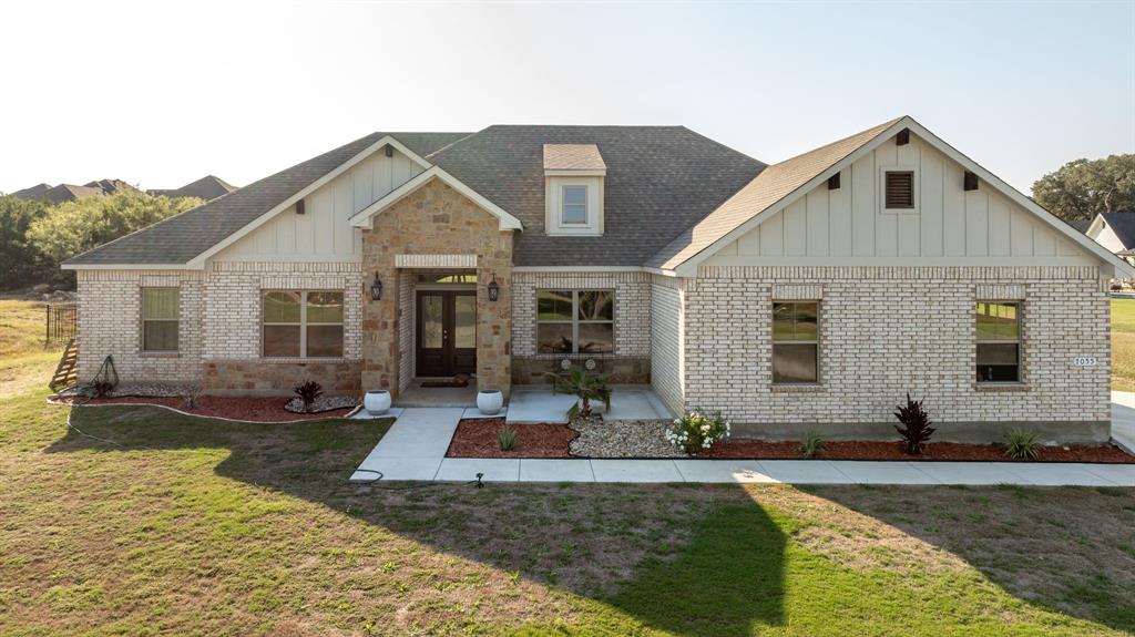 a front view of a house with yard outdoor seating