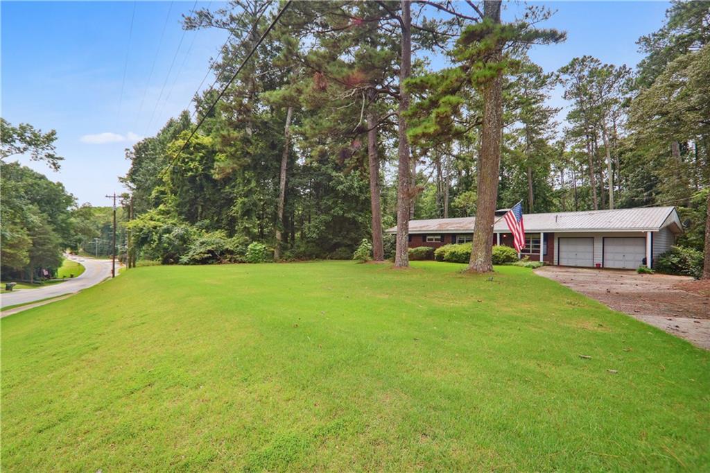 a view of a house with backyard and a patio