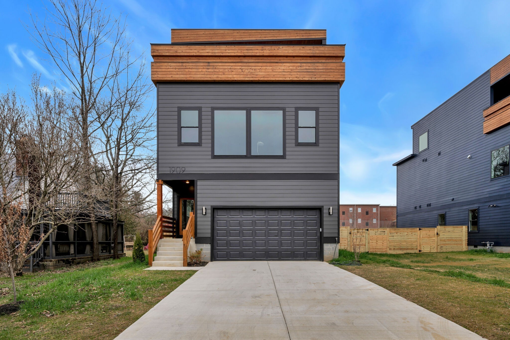 a front view of a house with a garden