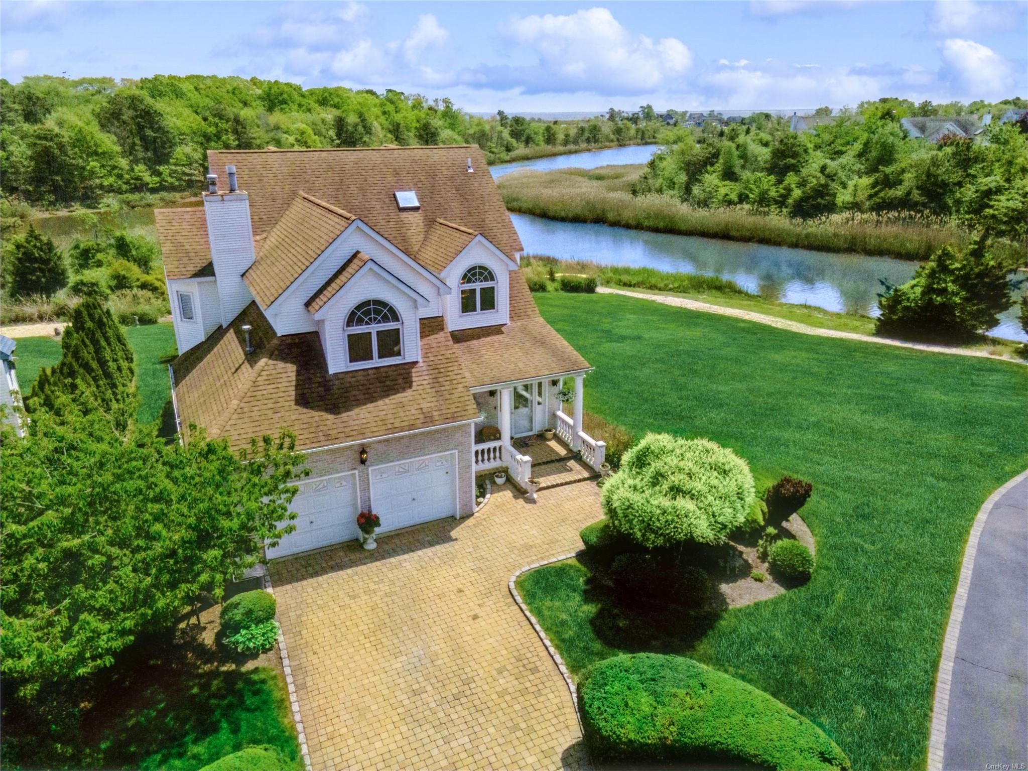 a aerial view of a house with a yard and a large pool