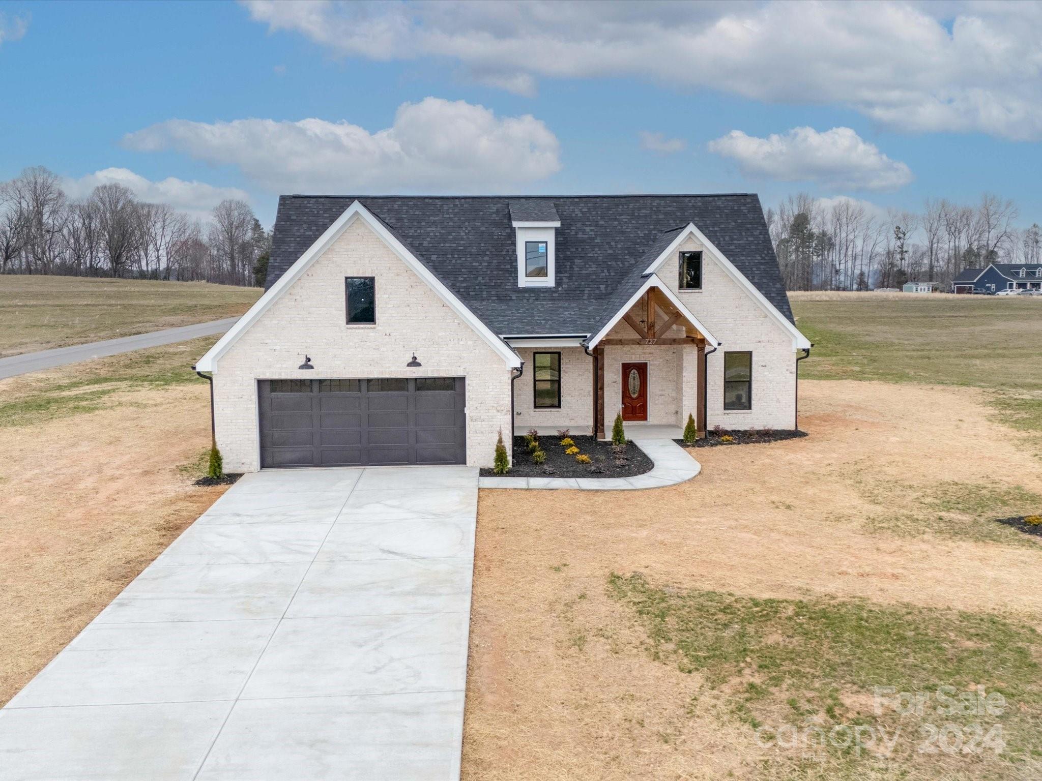 a view of a house with yard and wooden fence