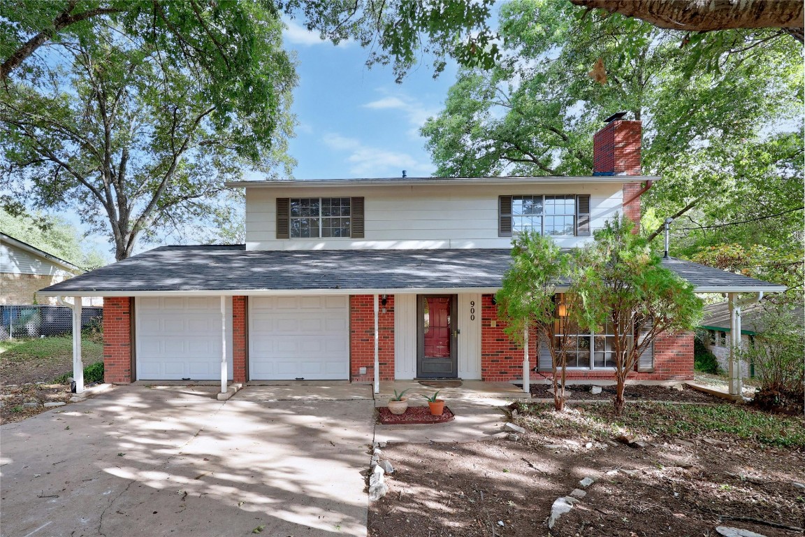 a view of a house with a tree in front of it