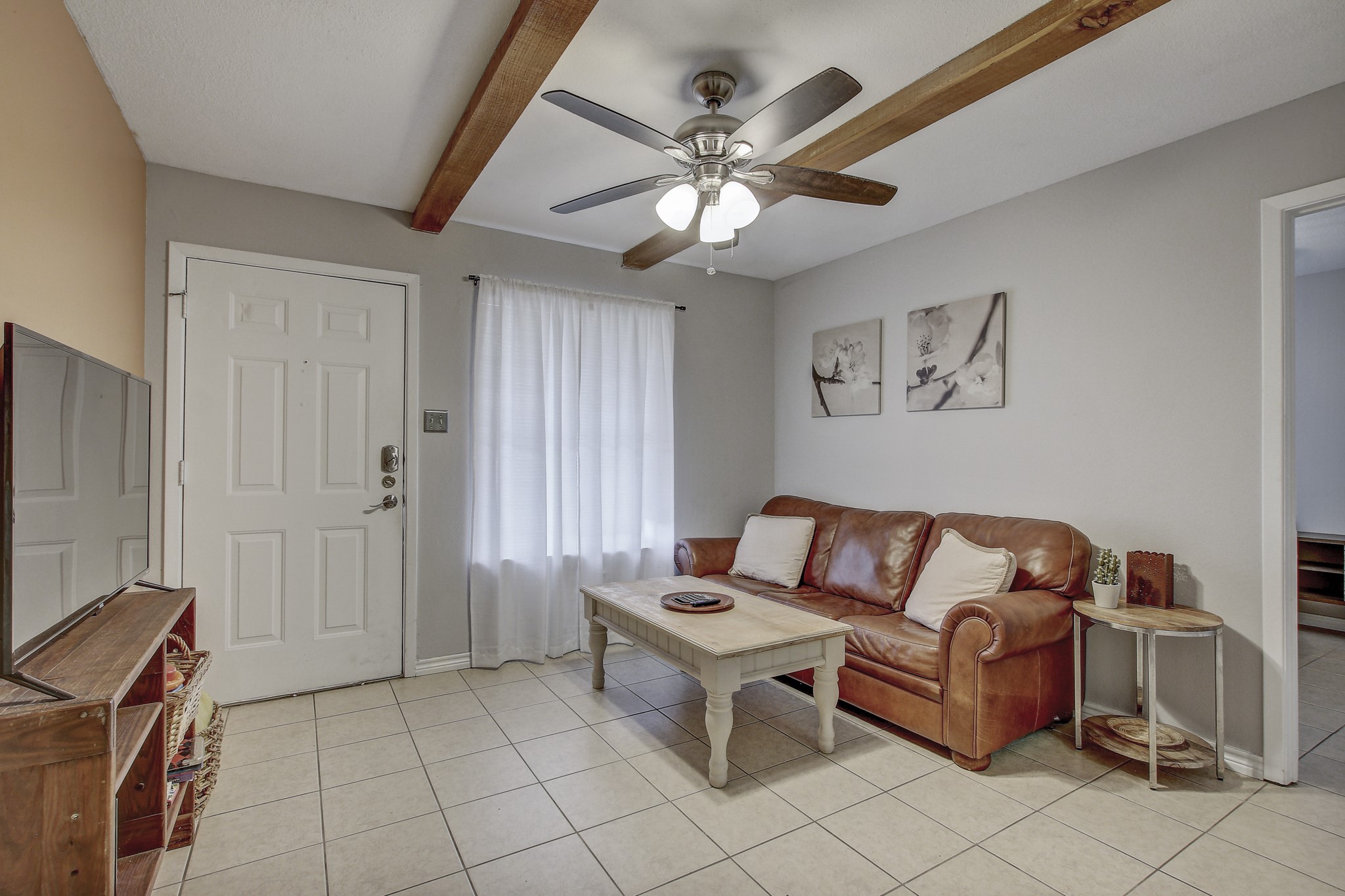 a living room with furniture and a flat screen tv