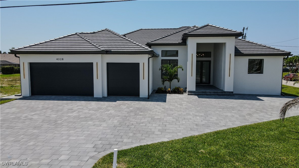 a front view of a house with a yard and garage