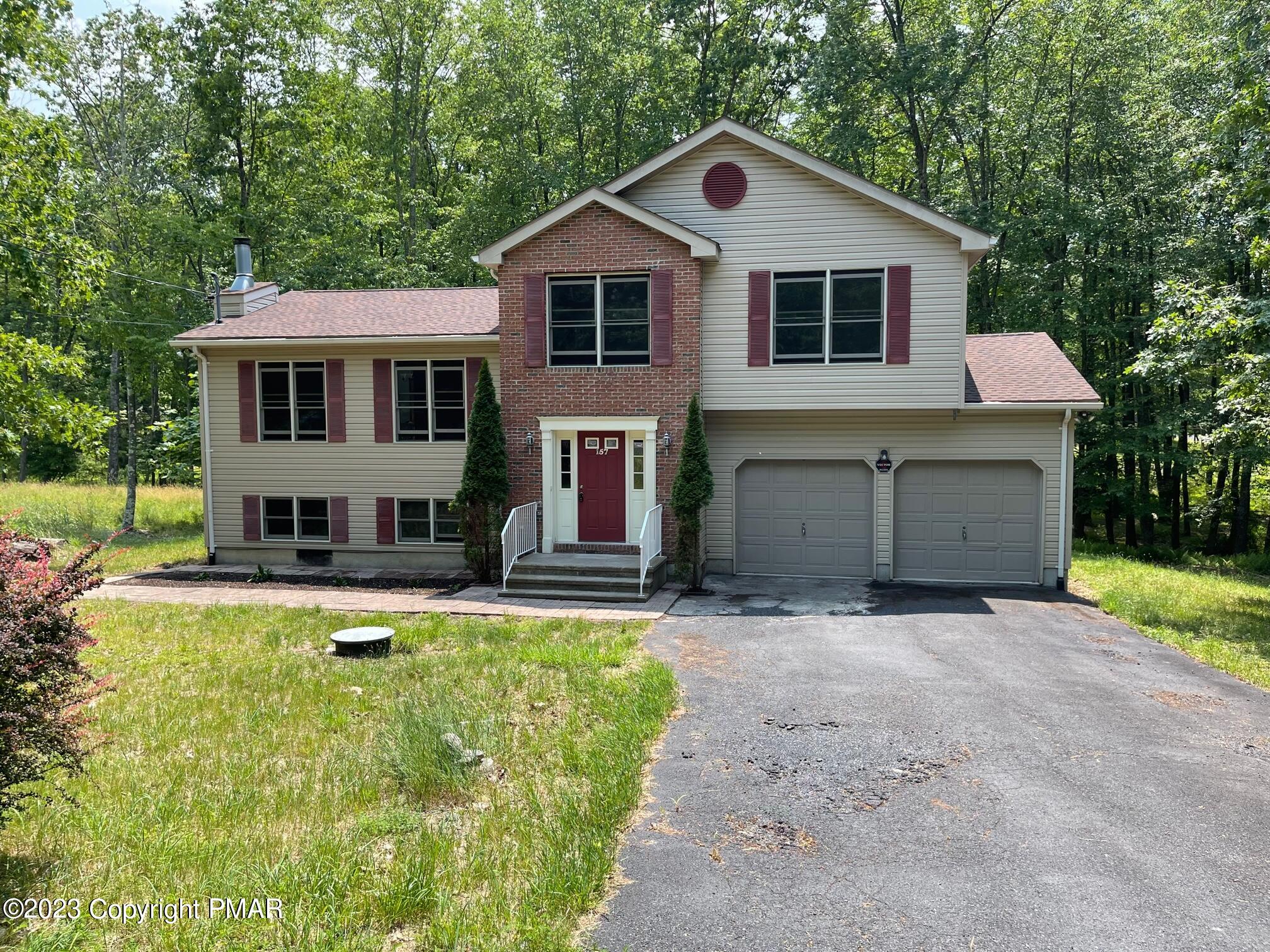 a front view of a house with a yard and garage