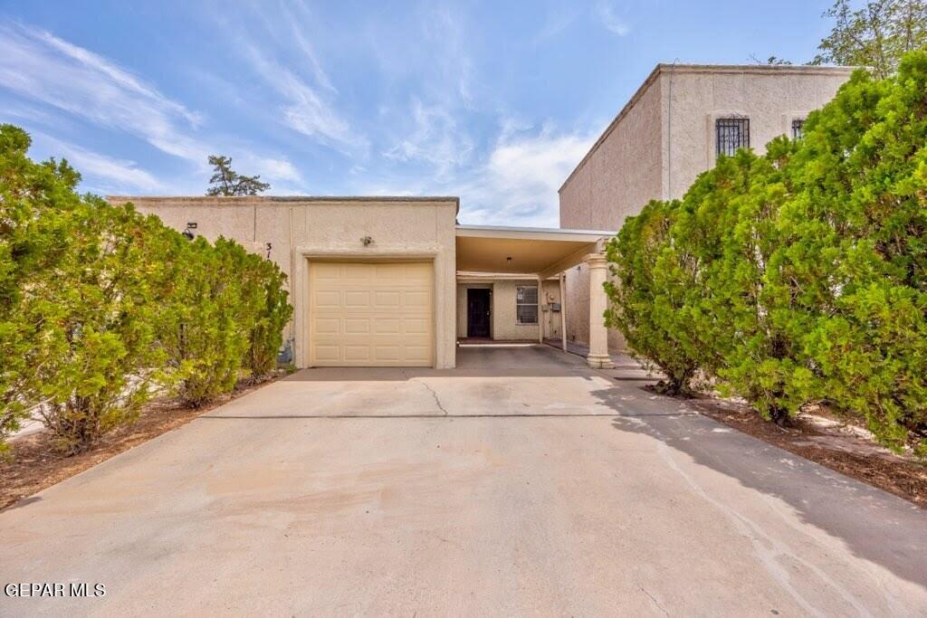 a view of a house with a yard and garage