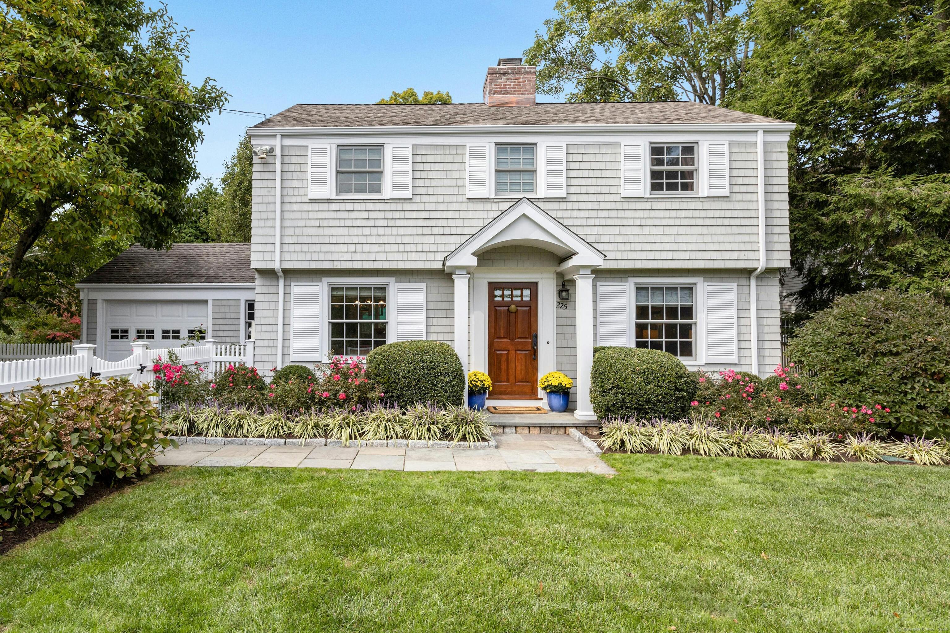 a front view of a house with a yard and porch