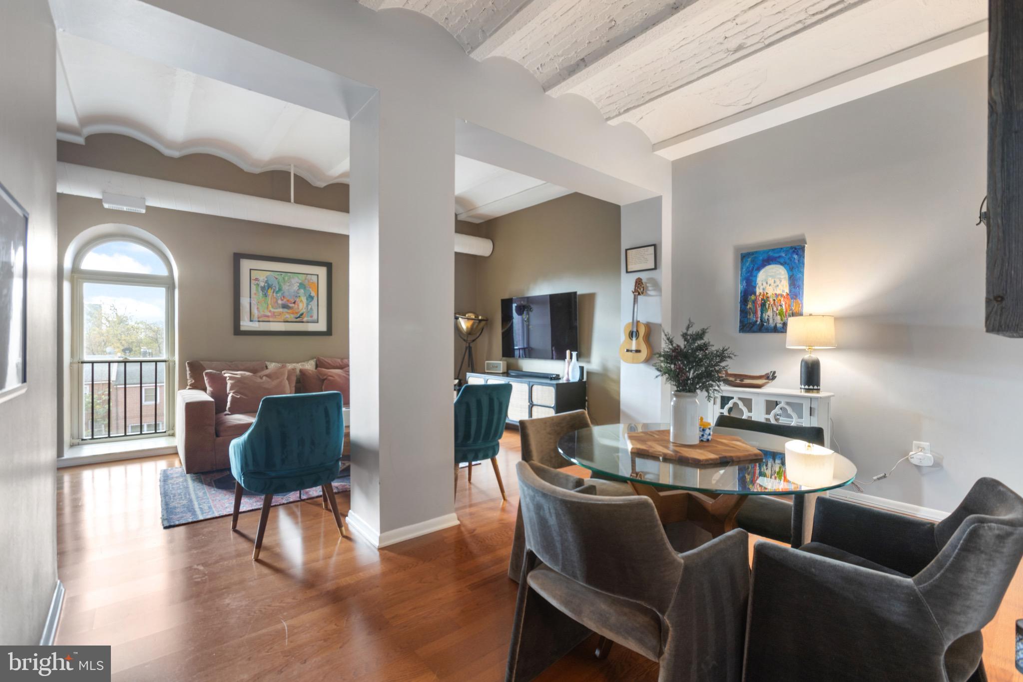 a dining room with furniture and wooden floor