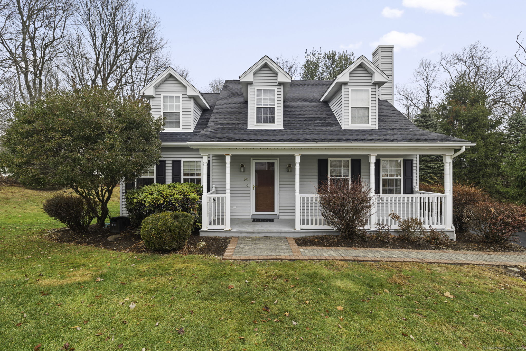 a front view of a house with a garden and porch