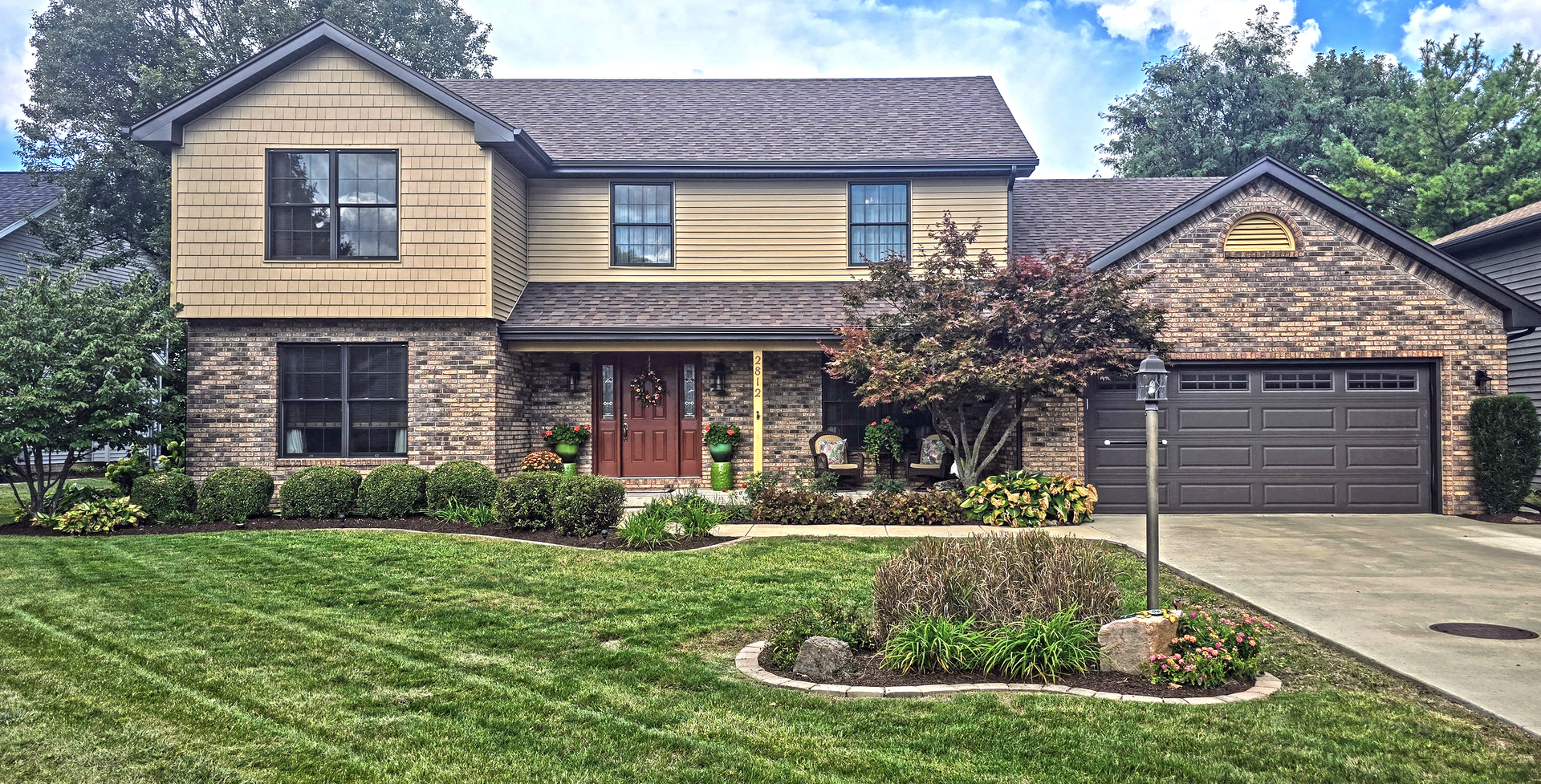 a front view of a house with garden