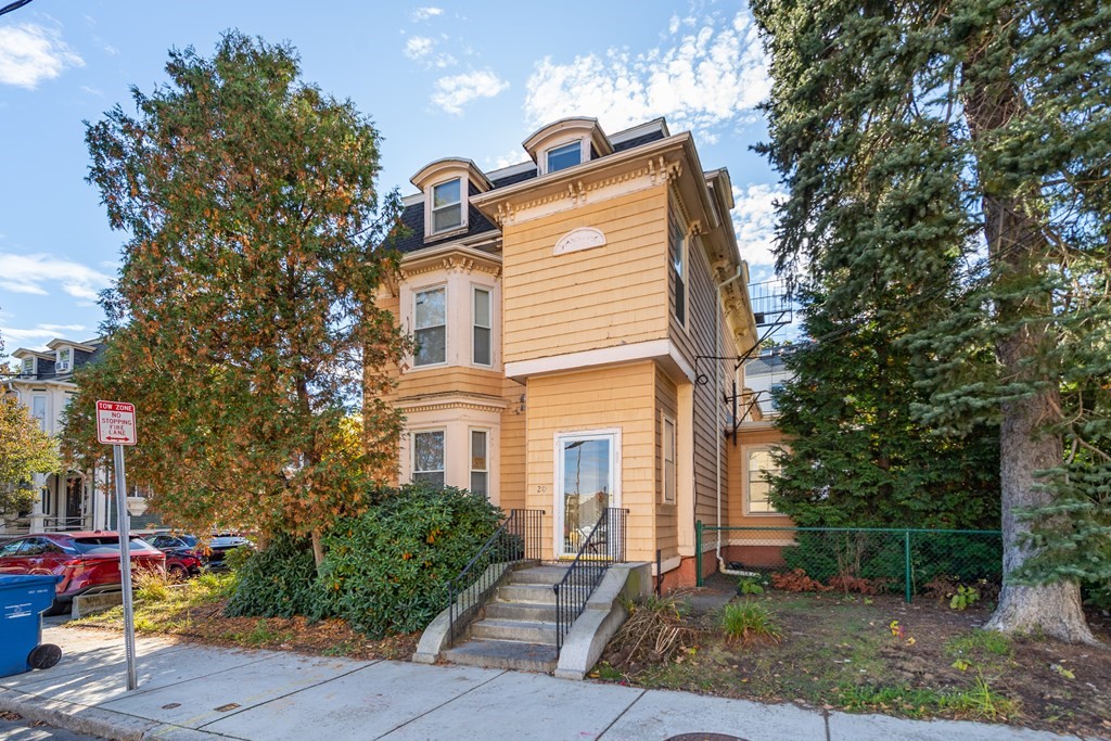 a front view of a house with garden