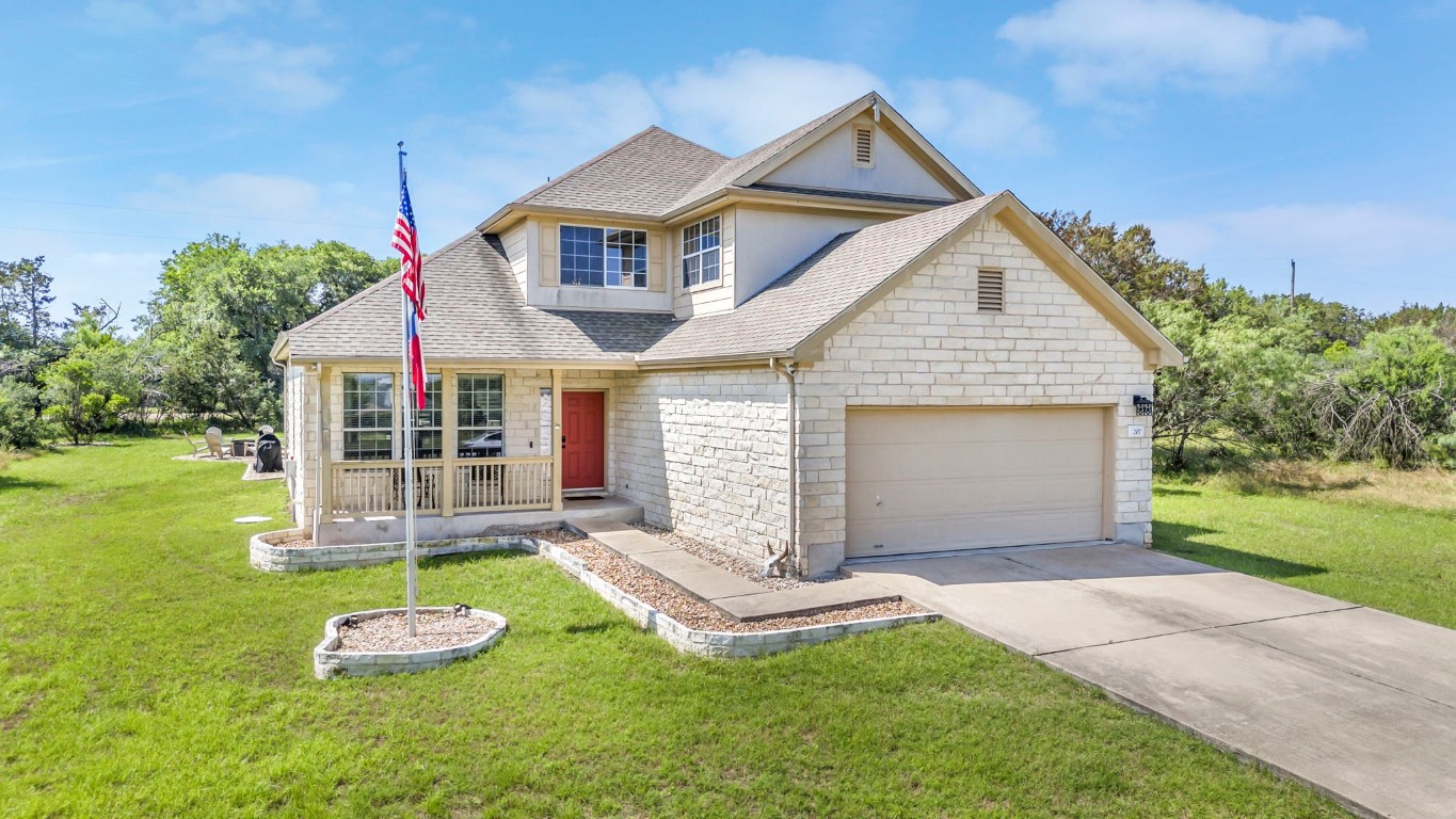 a front view of a house with a yard and garage