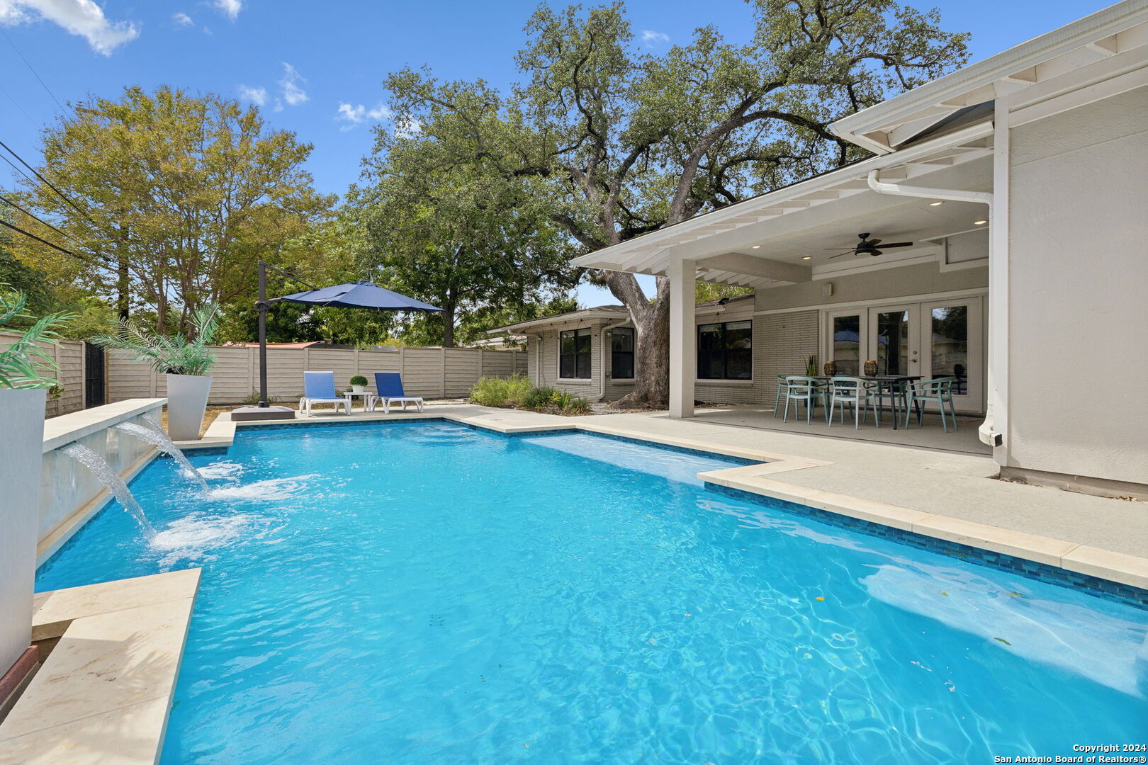 a view of a house with swimming pool and sitting area