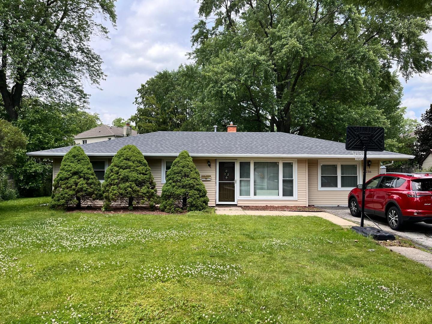 a front view of a house with a garden