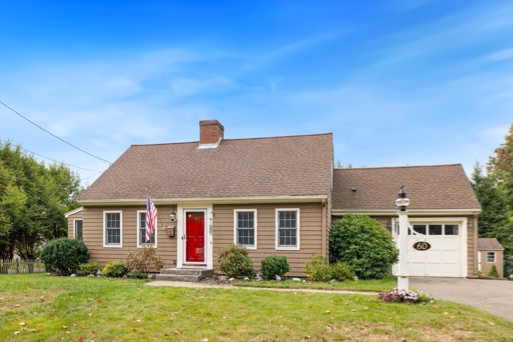 a front view of house with yard and green space